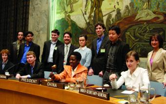 U.N. official Fernando Ortiz Jr. ’79 (standing, fourth from left) led students on a behind-the-scenes tour, including a chance to sit in delegates’ seats in the Security Council chamber.